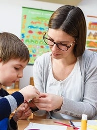 Teacher with child in classroom