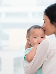 Mother holding young child