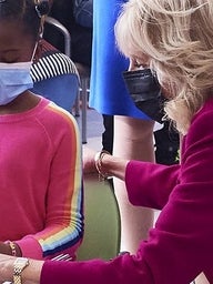 Jill Biden with a little girl at Karabots