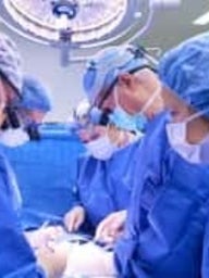 doctors operating on fetal surgery patient for spina bifida