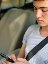 Teen driver looking at phone