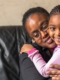 Mother hugging daughter