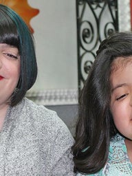 Two girls smiling with new haircuts