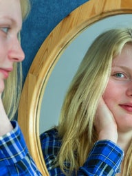 Girl smiling in mirror