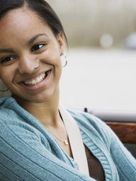 Teen girl driver in car smiling at father