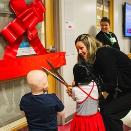 Patients and families cutting ribbon