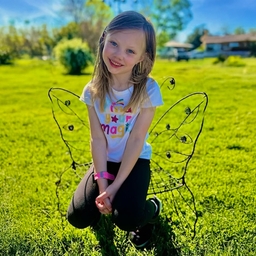 Cassidy in butterfly chair outside