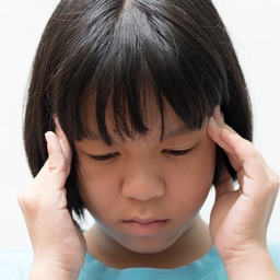 Girl holding her head