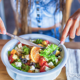 young woman eating salad