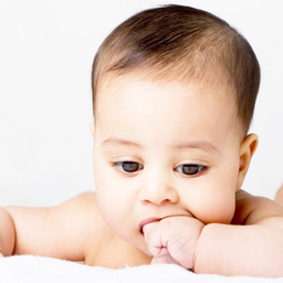 Teething baby chewing on hand