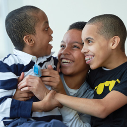 Mom with 2 sons smiling