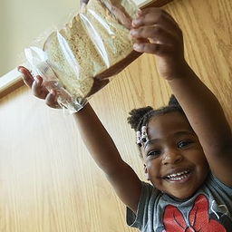 Child holding a sandwich