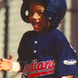 young roberto playing baseball