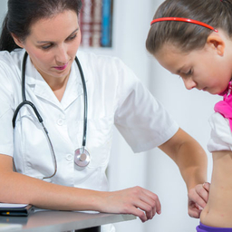 Doctor examining a child's stomach