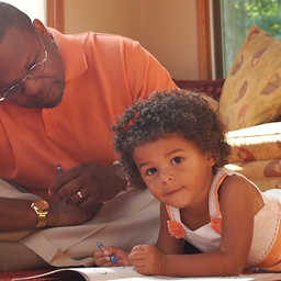 father sitting with young daughter