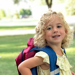 Maeve with her school backpack