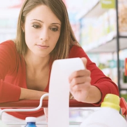 upset woman holding grocery receipt