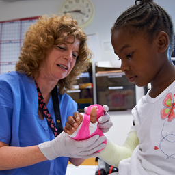 girl having cast applied to arm