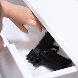 little girl reaching for gun in drawer