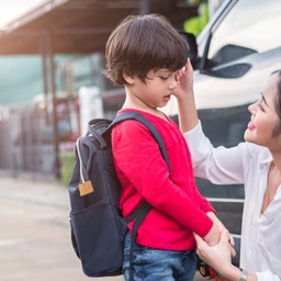 Mother with son holding backpack