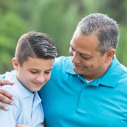 Father with arm around son