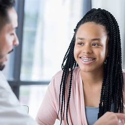 Doctor talking to teen patient