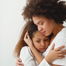 Mother hugging distraught daughter