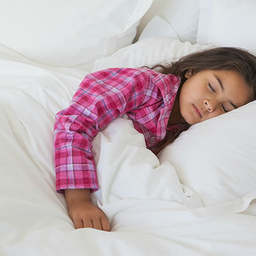 Older female toddler sleeping in bed