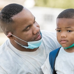 Father consoling young son