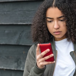 Teen girl looking at her smartphone