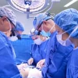 doctors operating on fetal surgery patient for spina bifida