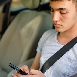 Teen driver looking at phone