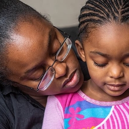 Mother holding daughter close