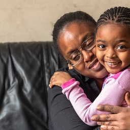 Mother hugging daughter