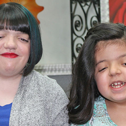 Two girls smiling with new haircuts