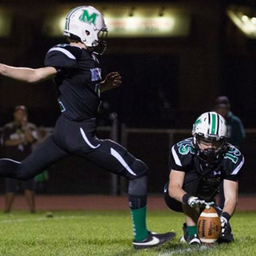 Sean kicking a football