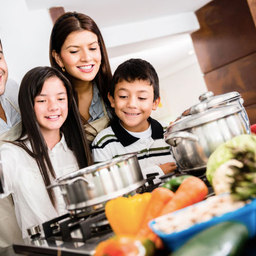 Family in kitchen cooking healthy meal together