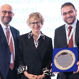 People holding an award