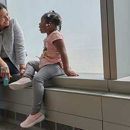 Doctor talking to child next to window