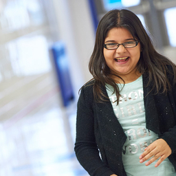 Young girl in hallway smiling