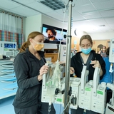 Two nurses monitoring critical equipment