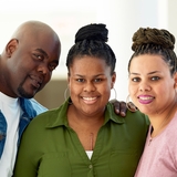 parents smiling with their daughter that has a heart transplant scar.