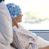 Woman with cancer looking out of window