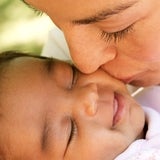 Mom kissing baby